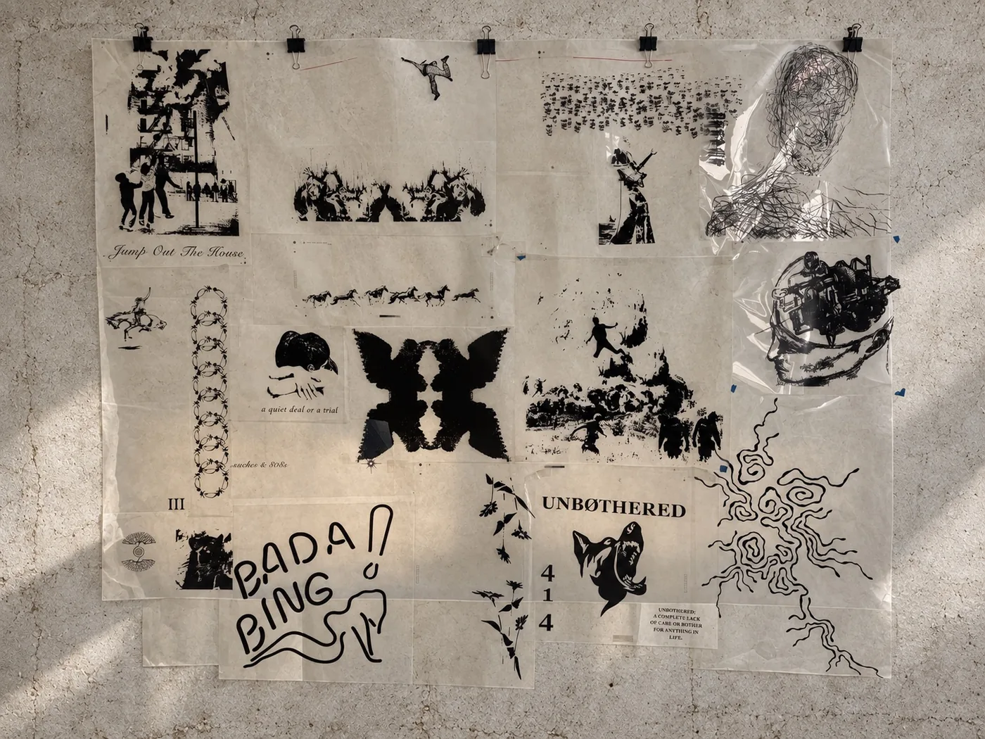 Original screen-print designs on overlapping transparency sheets against an edited concrete wall